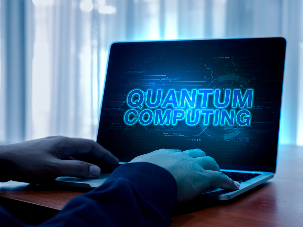 Photo of a blue-ish tinted computer screen reading Quantum Computing.
