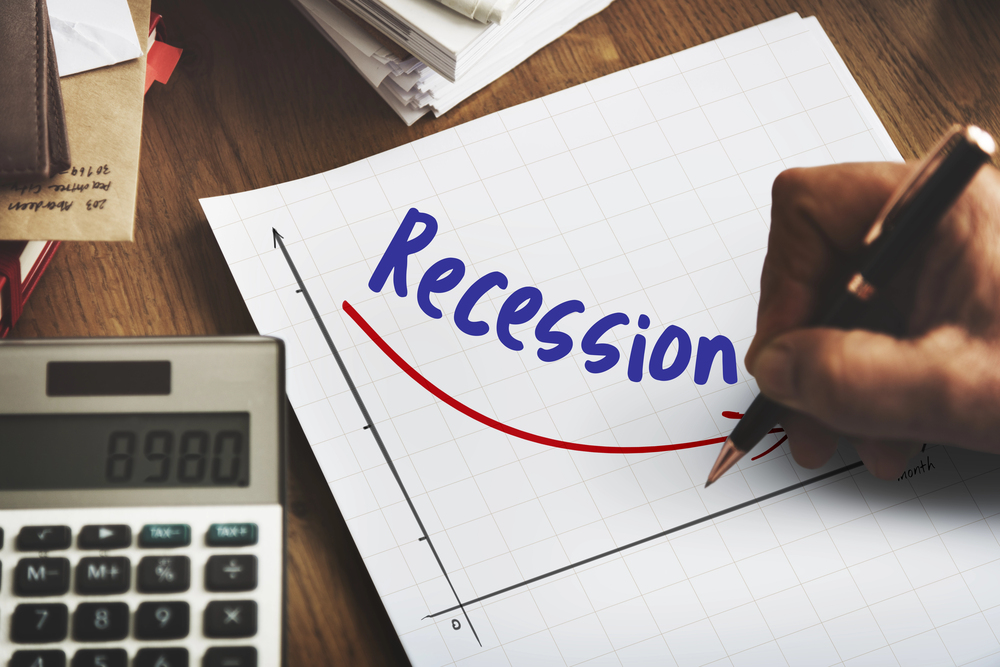 Business person writing notes: recession — Photo