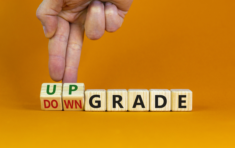 Photo of a hand flipping letters on wooden blocks between up and down grade