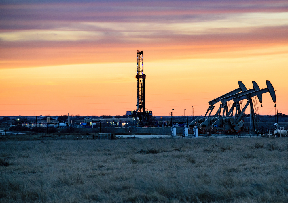 Photo of oil rigs at sunset