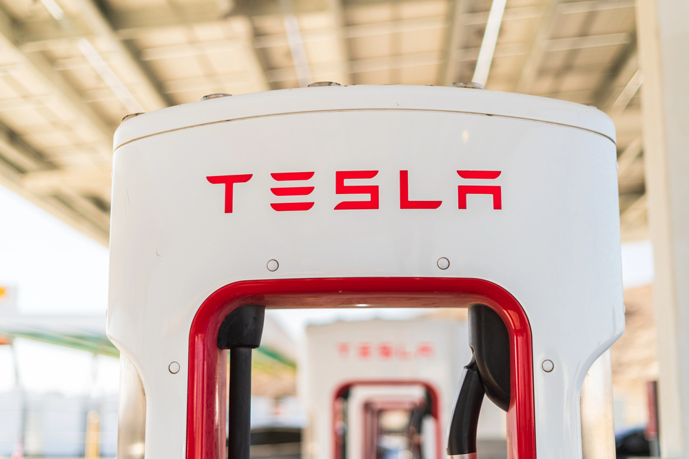 Baker, California, USA-October 12, 2021 - Tesla supercharging station during the day. — Stock Editorial Photography