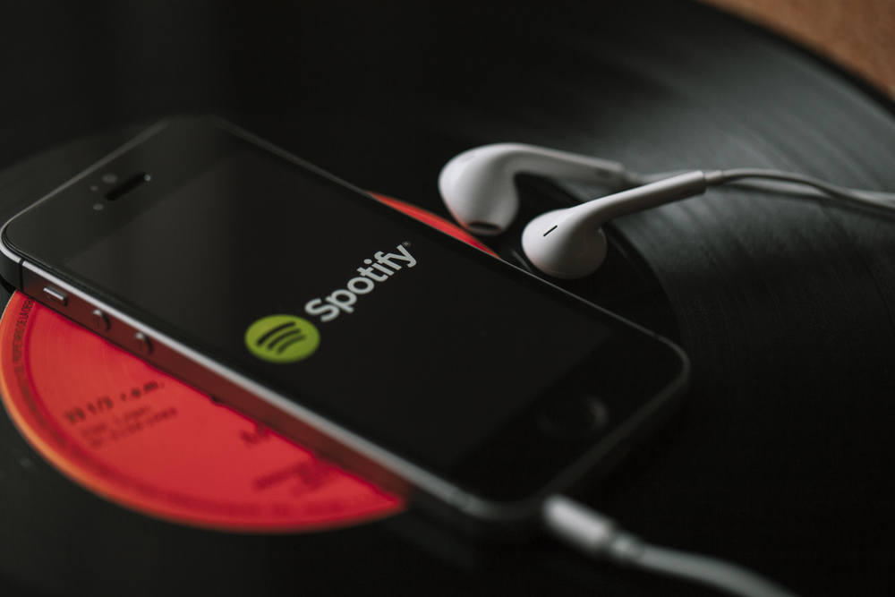 Spotify app on smartphone with headphones