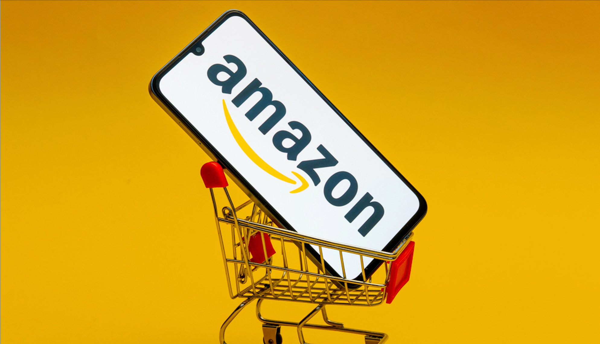 Kostanay, Kazakhstan, August 31, 2023. Smartphone with amazon logo, shopping basket and bank cards blue background.Concept online shopping - Stock Editorial Photography