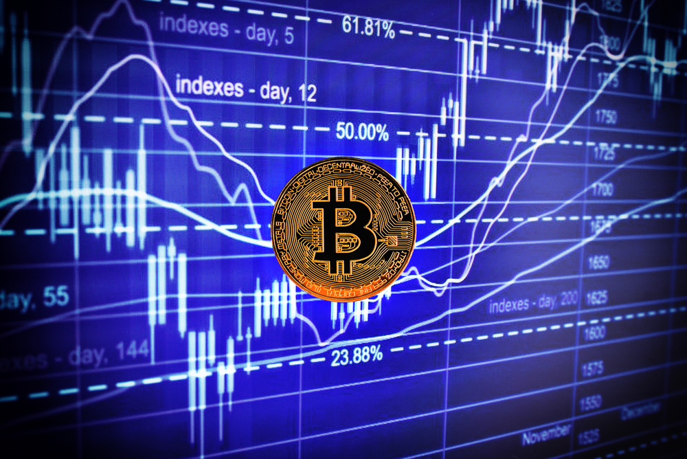 coin bitcoin against the background of the monitor with quotations of the exchange rate