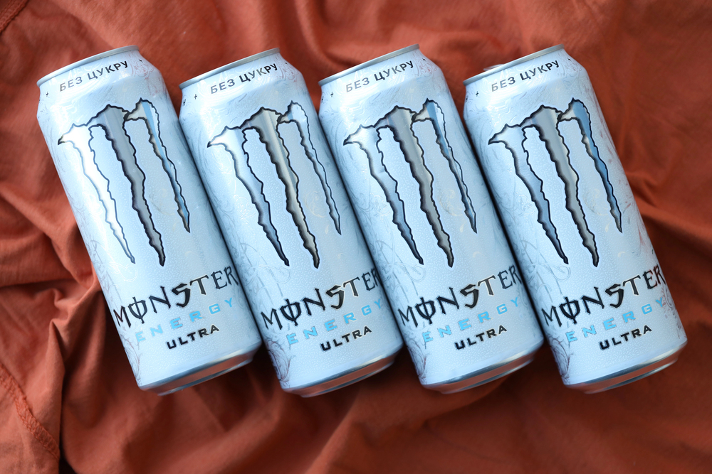 KYIV, UKRAINE - APRIL 20, 2024 Can of Monster Energy Drink ultra on fabric background. Introduced in 2002 Monster now has over 30 different drinks with high a caffeine content — Stock Editorial Photography