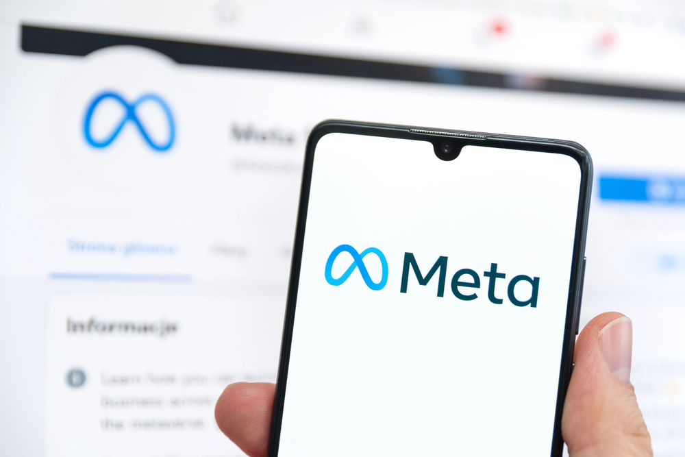Wroclaw, Poland - APR 01, 2022: Facebook changes its company name to Meta. Meta on a smartphone and Facebook logo in the background — Stock Editorial Photography