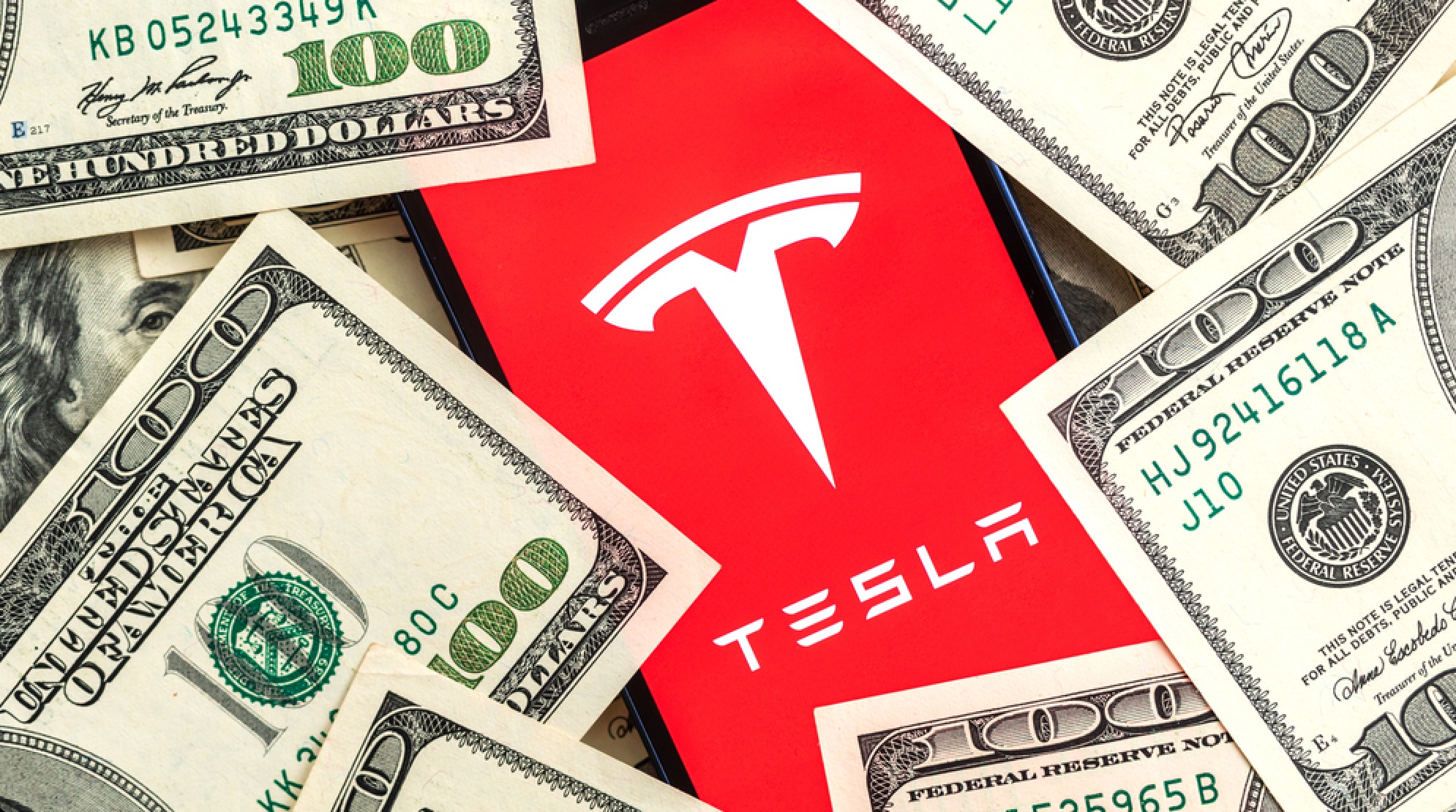 Poltava, Ukraine - April 26, 2022: Tesla car company stock market background. Tesla logo on Twitter and dollar money close-up view — Stock Editorial Photography