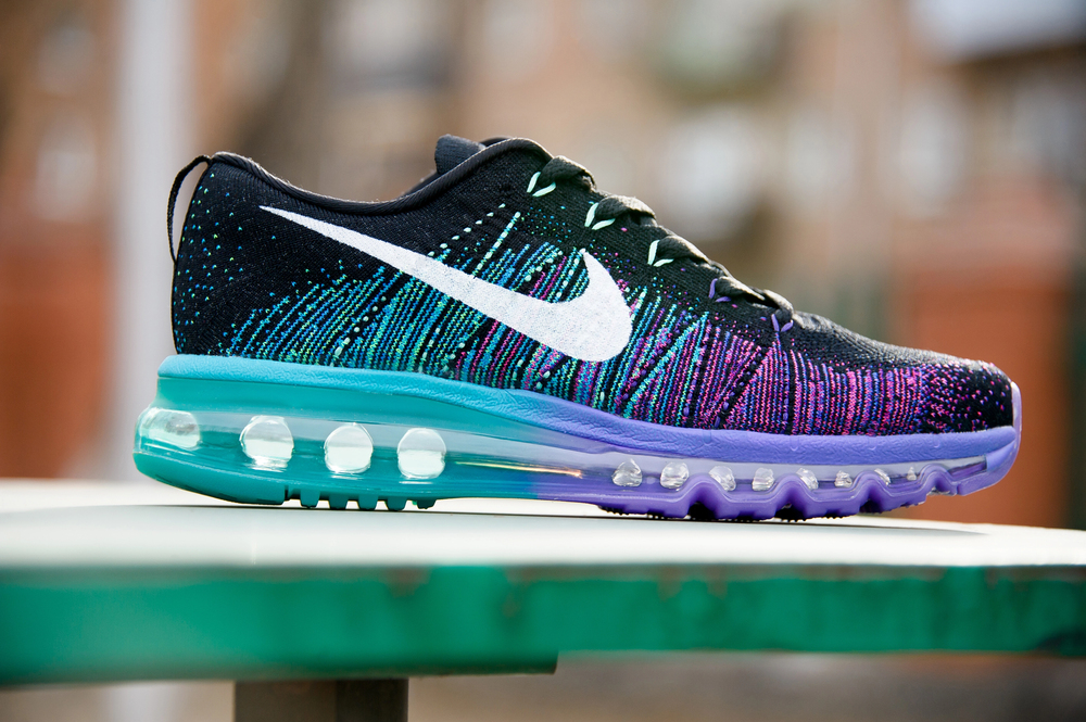 Colorful Nike Flyknit Air Max running shoes, sneakers, trainers close up view, shot on abstract background. Sport and casual footwear concept. Krasnoyarsk, Russia - Februsry 14, 2015 — Stock Editorial Photography