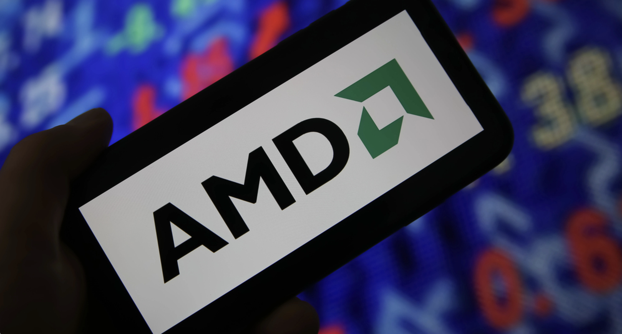 Viersen, Germany - June 6. 2021: Closeup of mobile phone screen with logo lettering of AMD, stock market chart background — Photo by mobilinchen