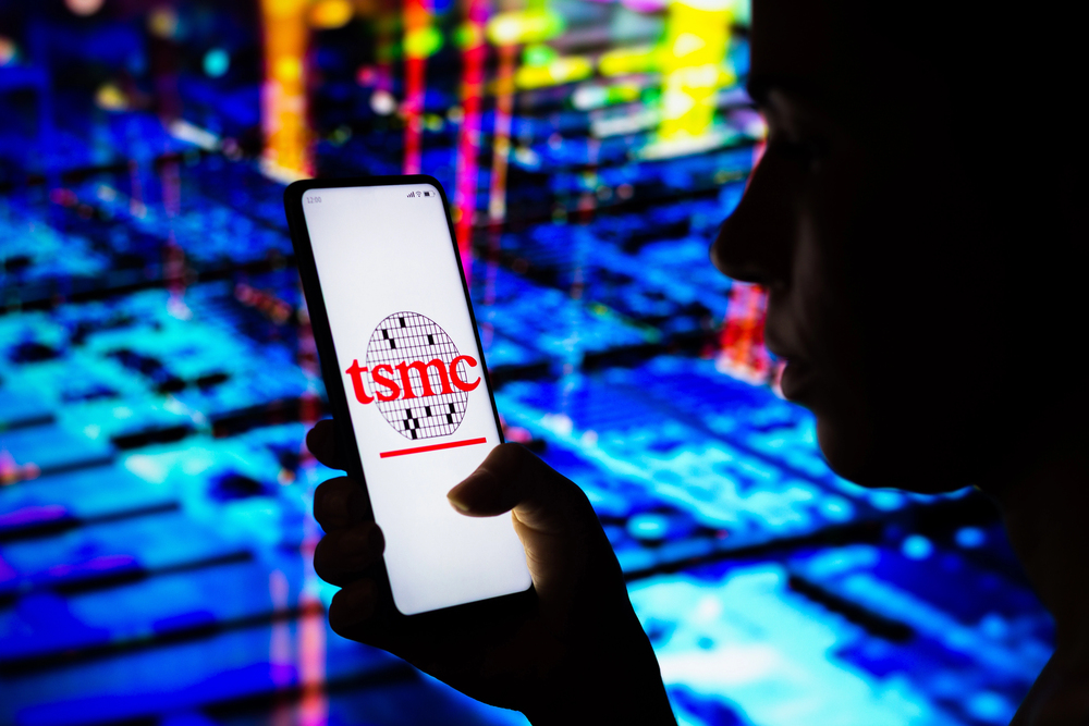 April 10, 2022, Brazil. In this photo illustration, a woman holds a smartphone with the Taiwan Semiconductor Manufacturing Company Limited (TSMC) logo displayed on the screen — Stock Editorial Photography