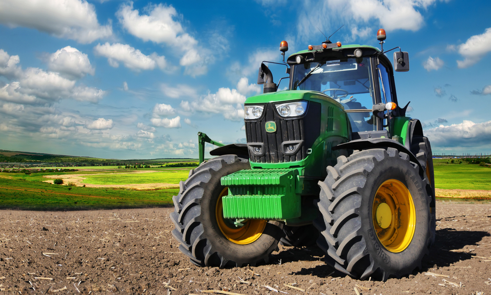 Modern, green tractor in the spring field work — Stock Editorial Photography