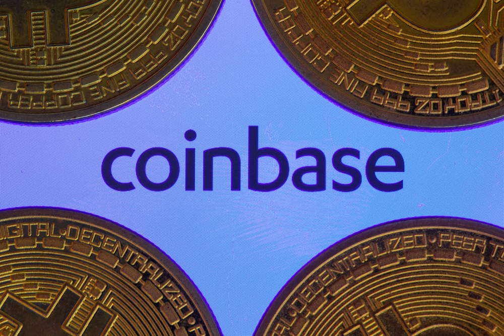 Coinbase logo on screen with Bitcoin coins. Ljubljana, Slovenia - April 06 2021