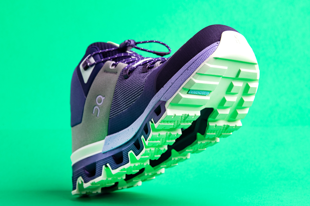 QC sports shoes on a green background close-up. Casual stylish shoes. - Stock Editorial Photography