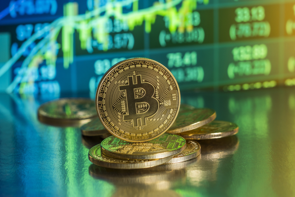 Bitcoin with chart background. New virtual cryptocurrency concept - Stock Editorial Photography