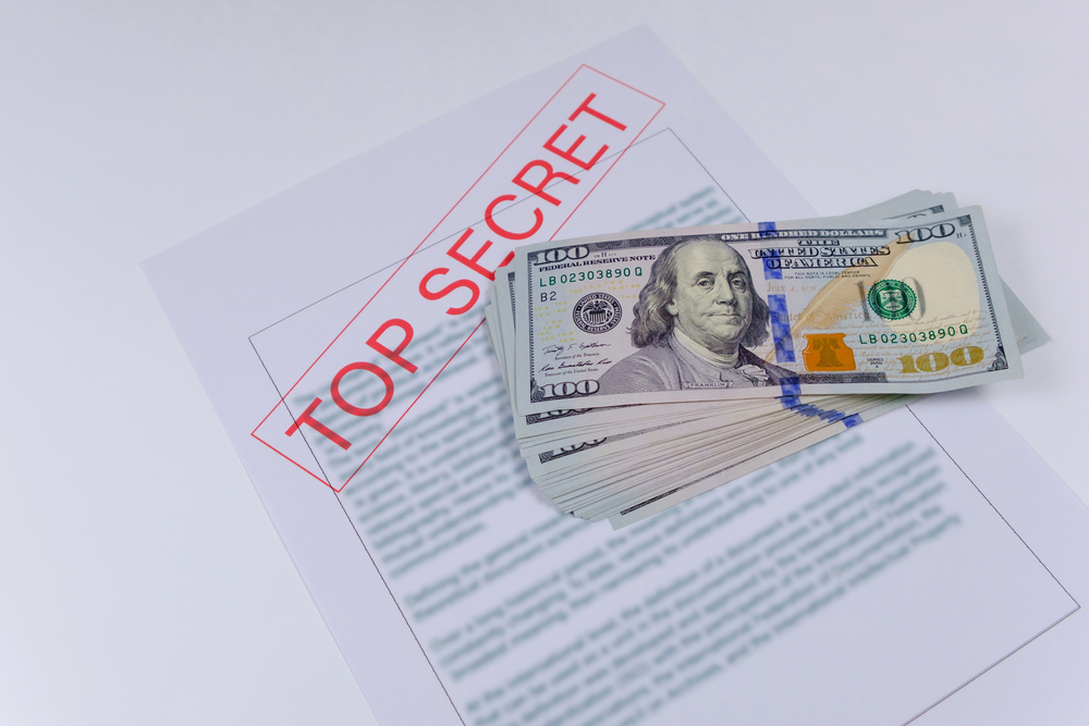 Secret documents and money on white background. Bribery and corruption concepts — Stock Editorial Photography