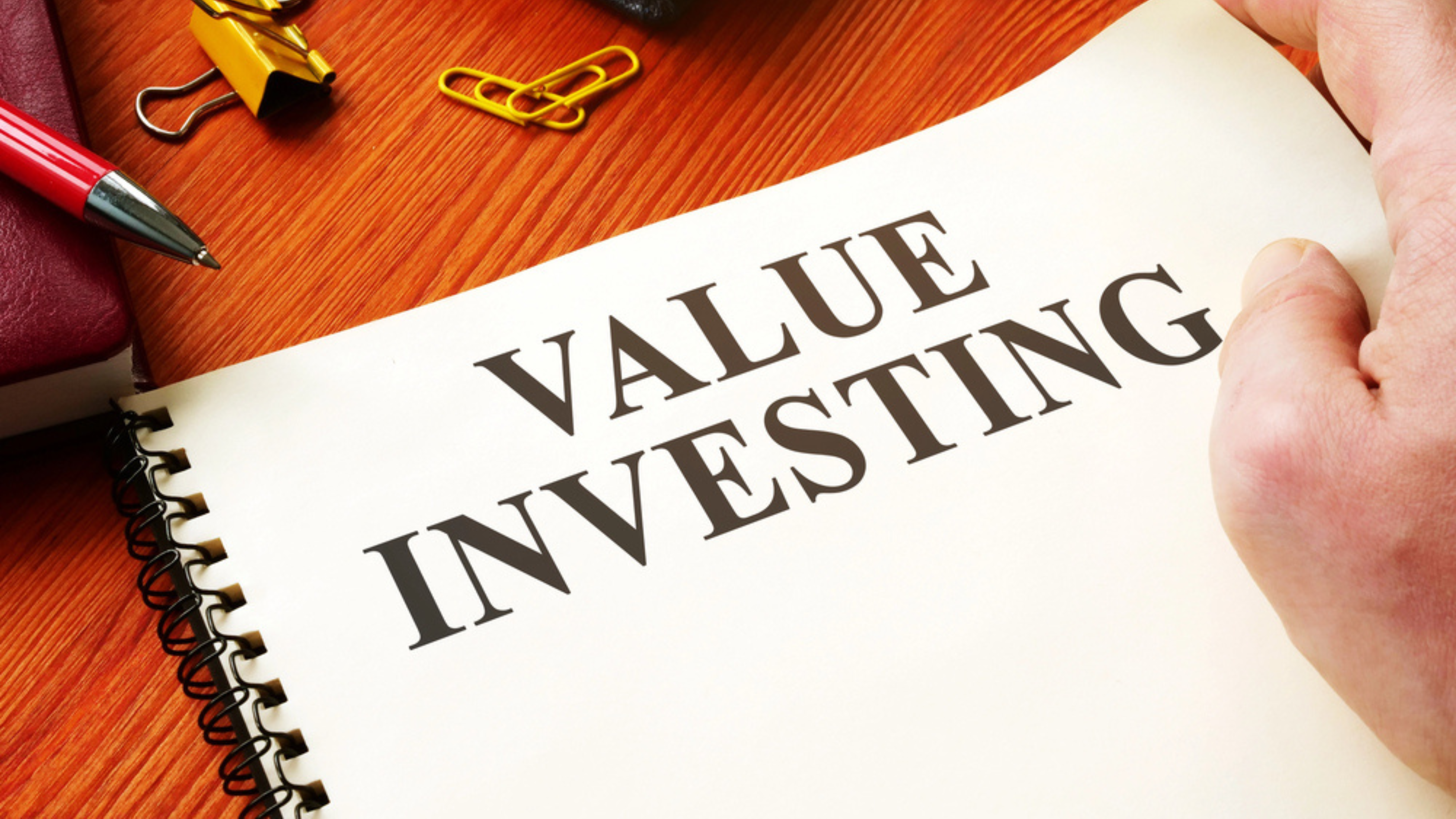Value investing written on notebook laid on desk