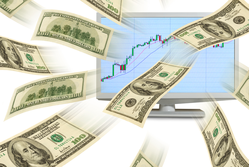 Cash dollars fly out of a computer monitor with the exchange schedule.