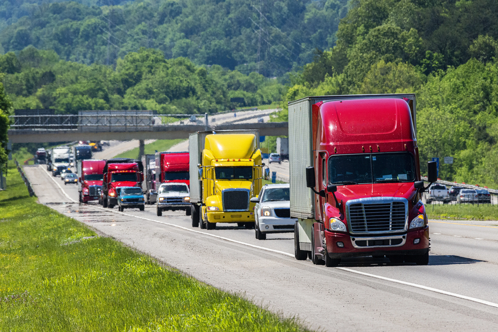 Red Semi Leads Traffic On Interstate — Photo