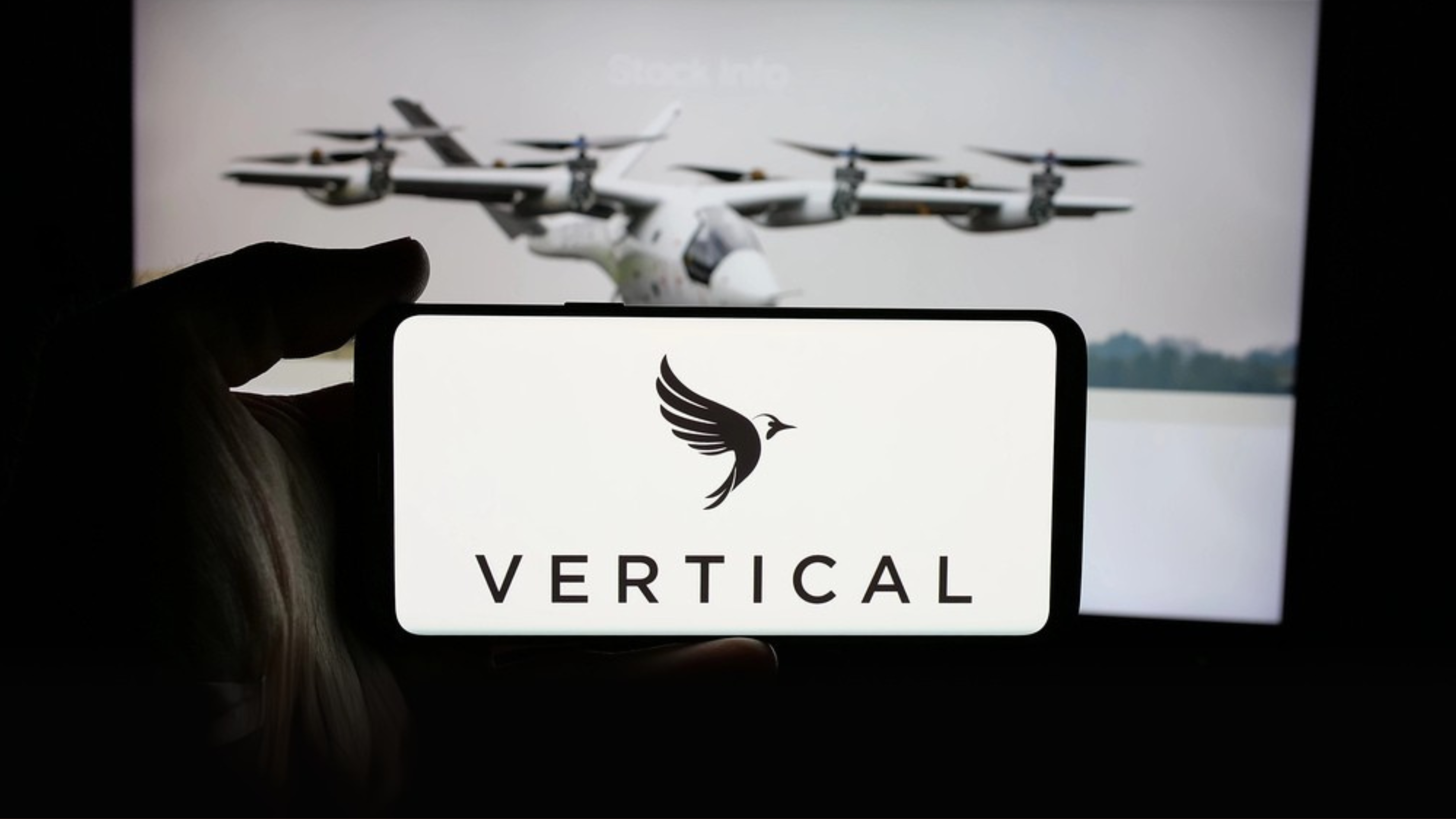 Vertical Aerospace logo on smartphone EVTOL in background
