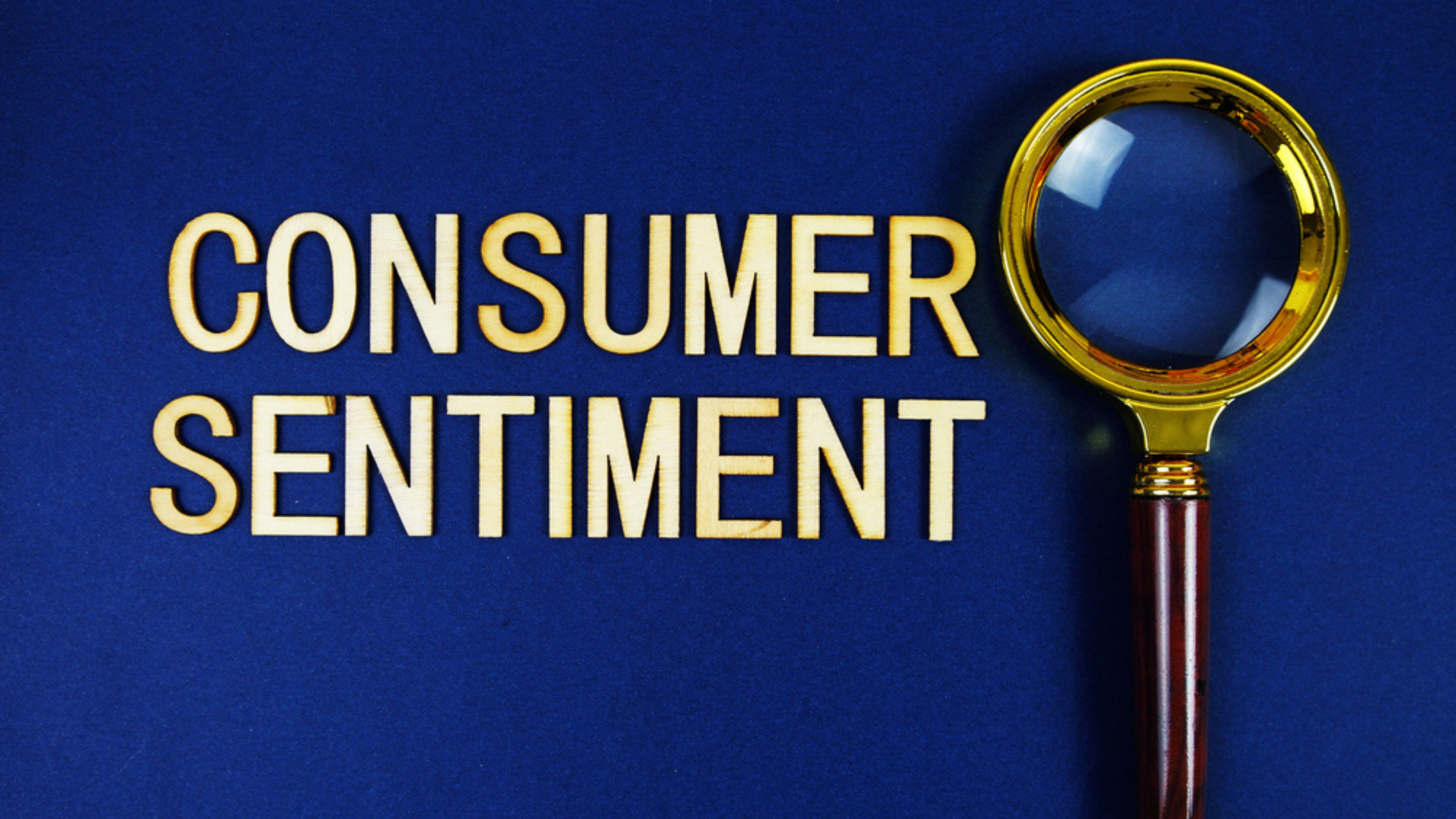 Consumer Sentiment alphabet letters with magnifying glass on navy blue background
