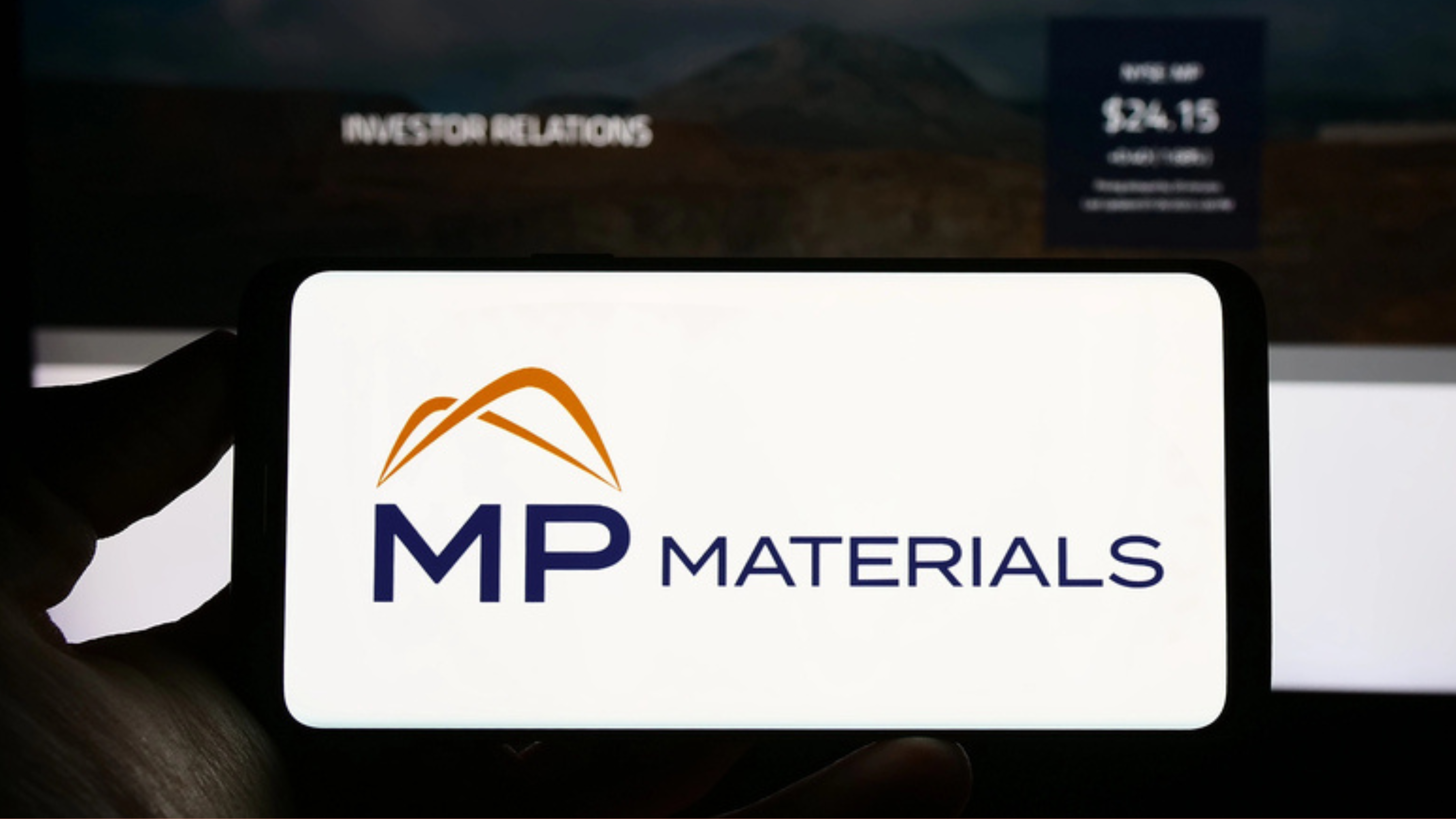 Stuttgart, Germany - 07-27-2023: Person holding cellphone with logo of US rare earths company MP Materials Corp. on screen in front of business webpage. Focus on phone display. - Stock Editorial Photography