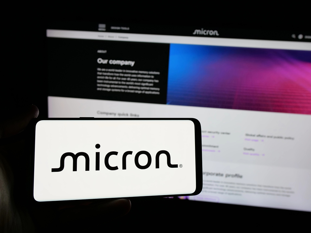 Stuttgart, Germany - 01-23-2025: Person holding smartphone with logo of US semiconductor company Micron Technology Inc. on screen in front of website. Focus on phone display. — Stock Editorial Photography