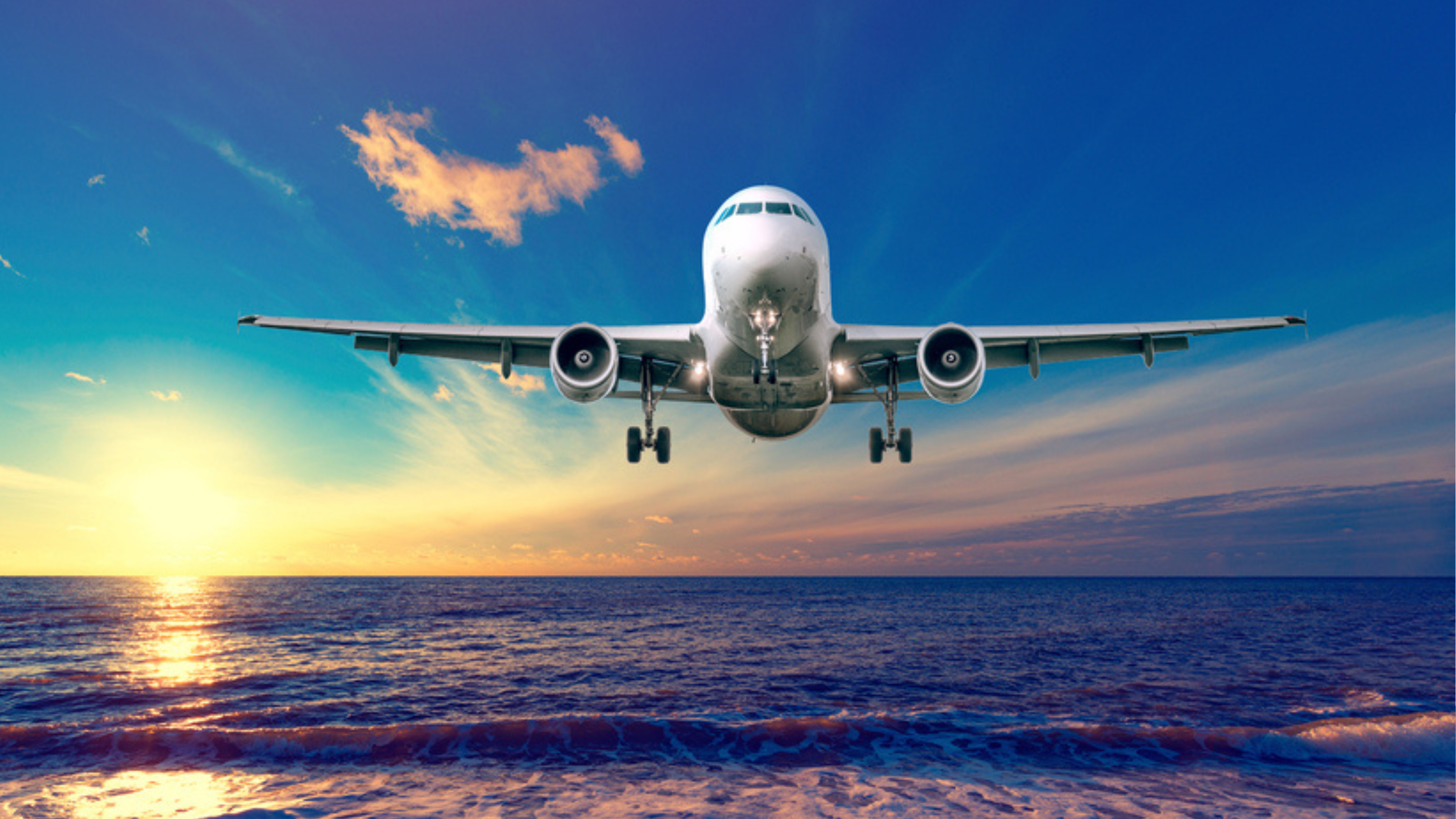 Flight of the plane over sea with sunset