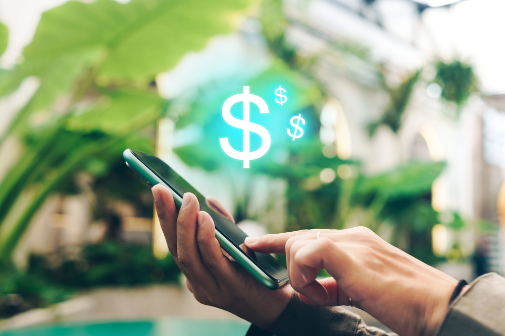 Woman use gadget mobile smartphone earn money online with dollar icon pop up. Business fintech technology on smartphone concept. — Photo