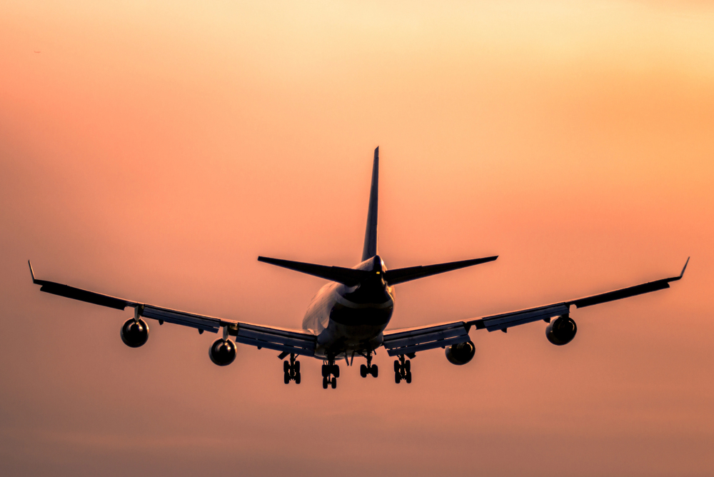 Boeing jet with sunset sky background