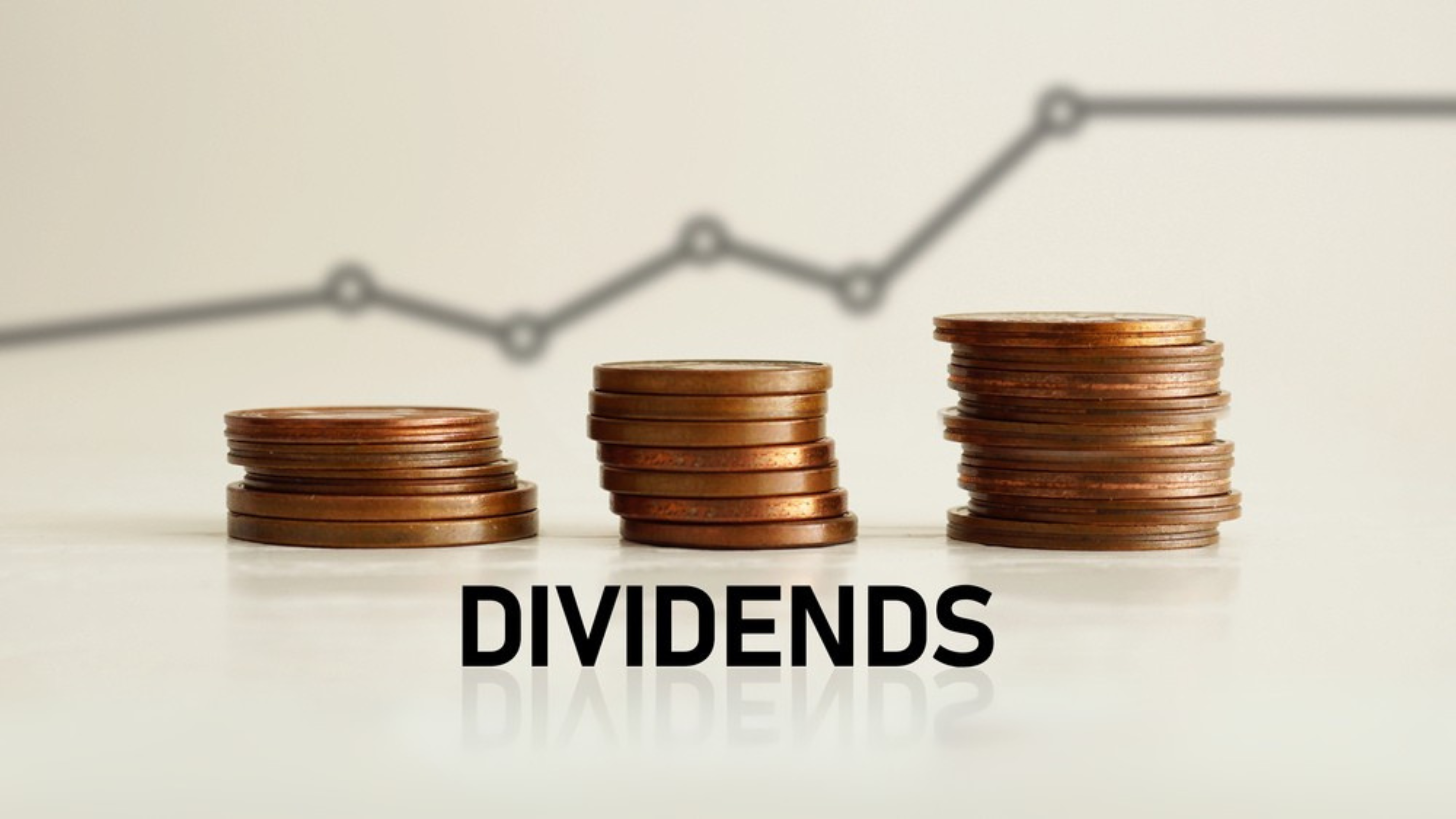 Dividends stacks of coins with line chart in background