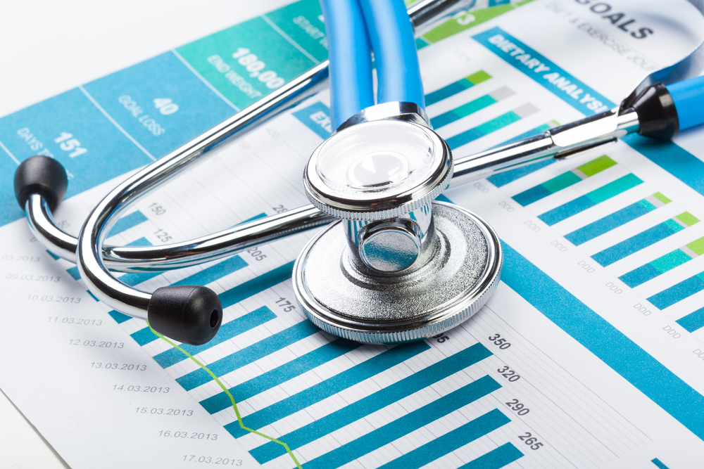 Stethoscope with financials on desk