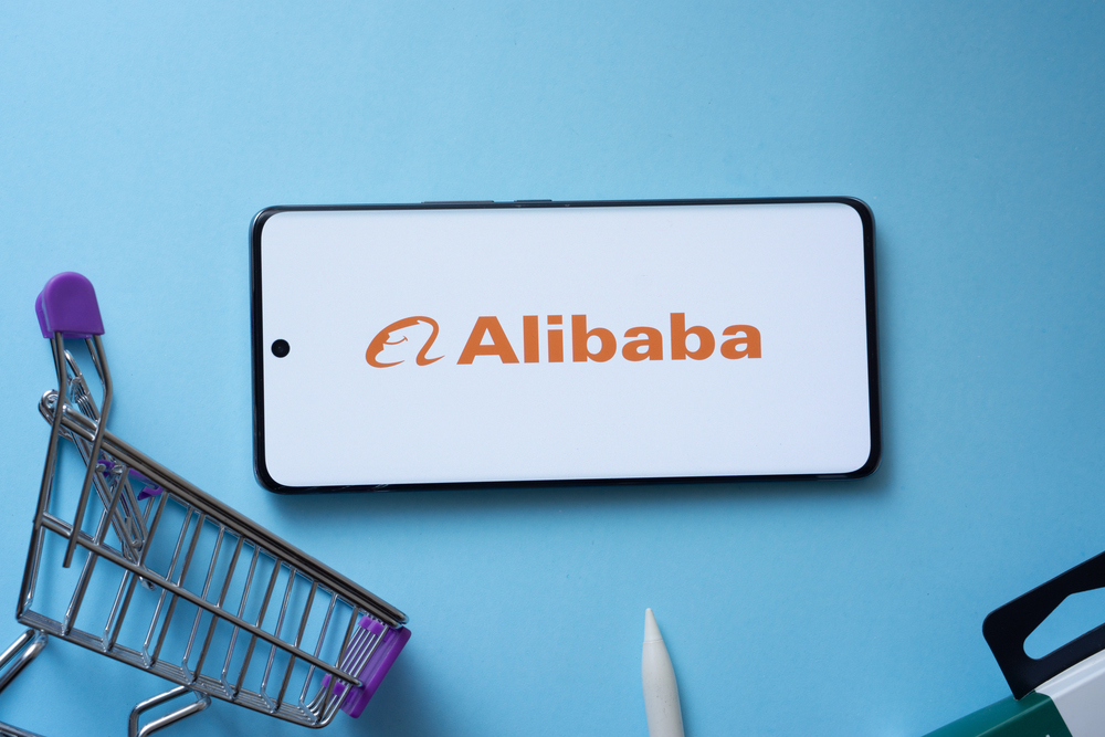 Dhaka, Bangladesh- 03 July 2025: Smartphone displaying Alibaba logo with shopping cart on a blue background.