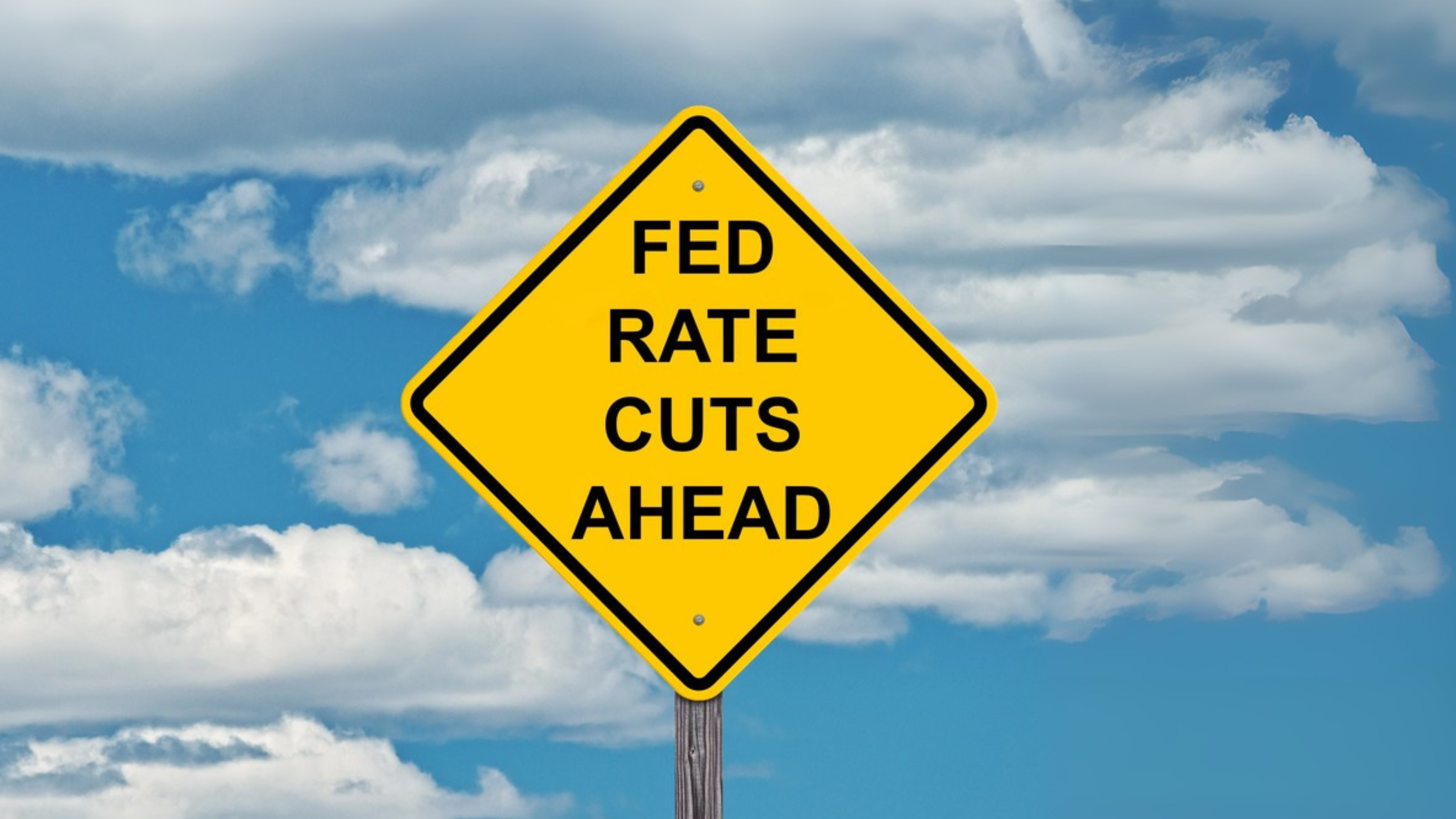 Fed Rate Cuts Ahead - Caution Sign Blue Sky Background
