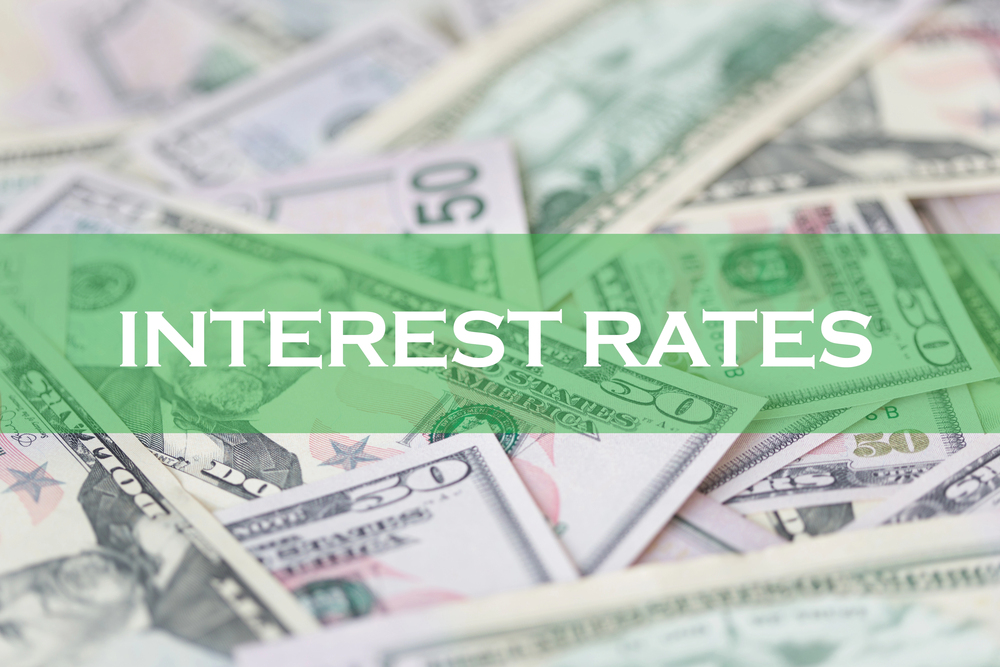 Interest rates text over dollar bills