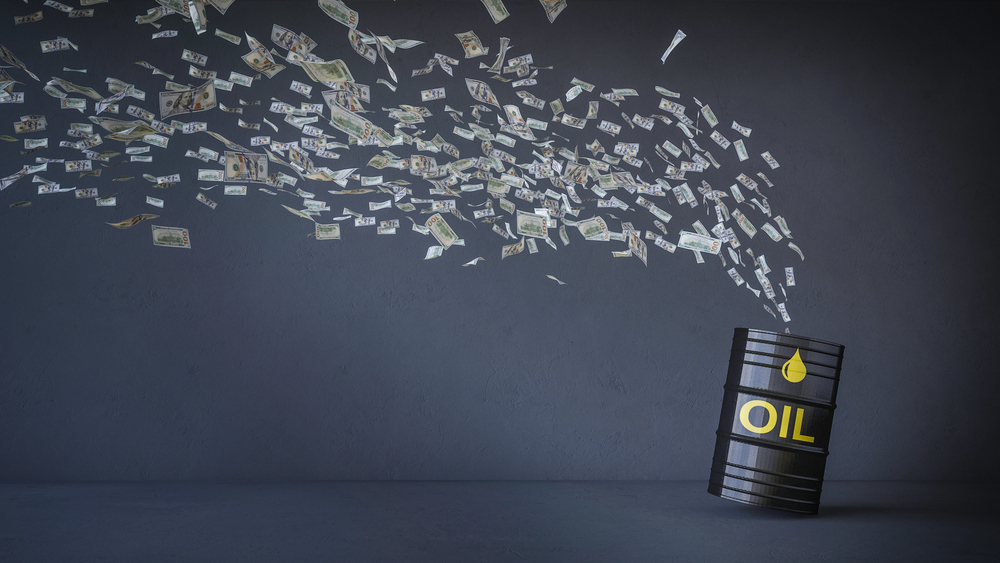 money flying out of an oil drum
