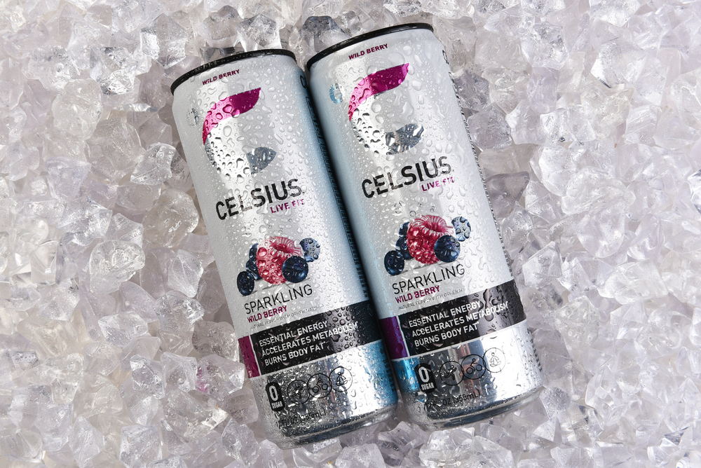 two cans of wild berry celsius laying on ice