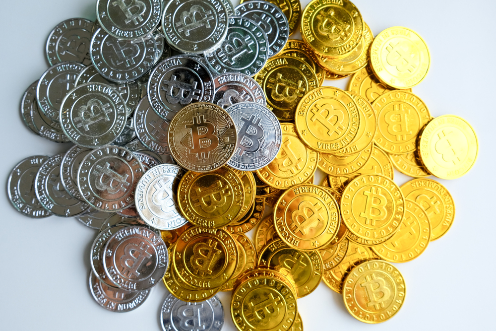 gold and silver bitcoins on a white background