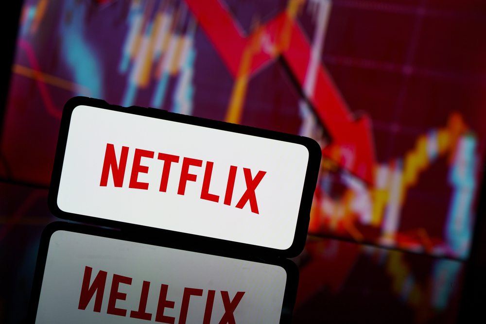 Netflix on cellphone with stock arrow 