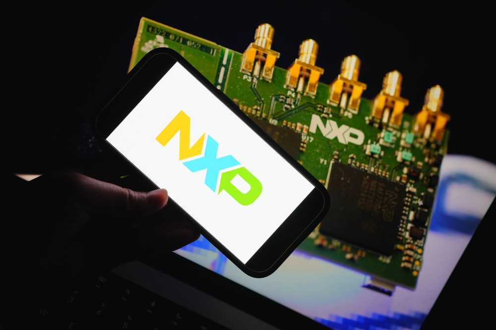 NXP logo on a smart phone, person holding phone, NXP semiconductor chip in the background
