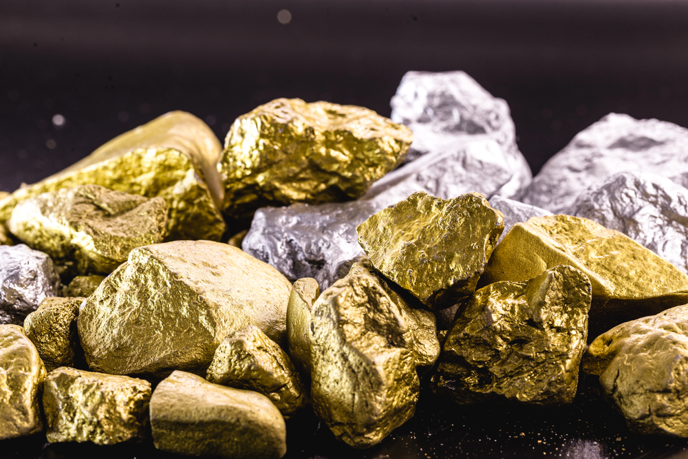 Nuggets of gold and silver piled up, precious stones used in the industry and jewelry. Concept of elux and wealth.