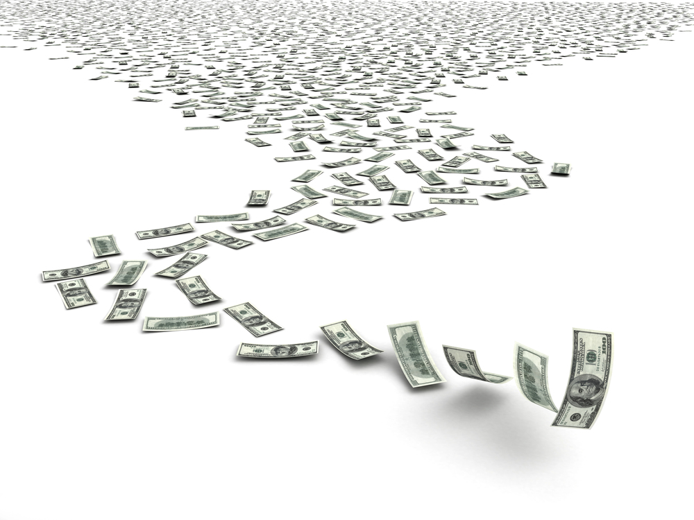 Hundred-dollar bills flowing forward on white background, symbolizing cash flow.