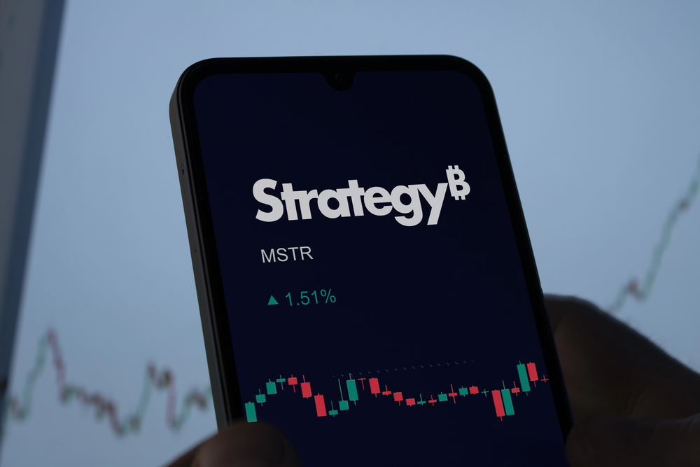 Phone screen showing Strategy (MSTR) stock chart, symbolizing Bitcoin investment strategy.
