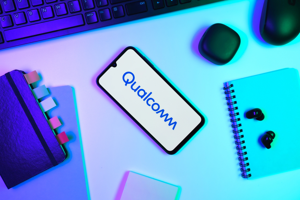 Qualcomm logo open on a smartphone on a desk.