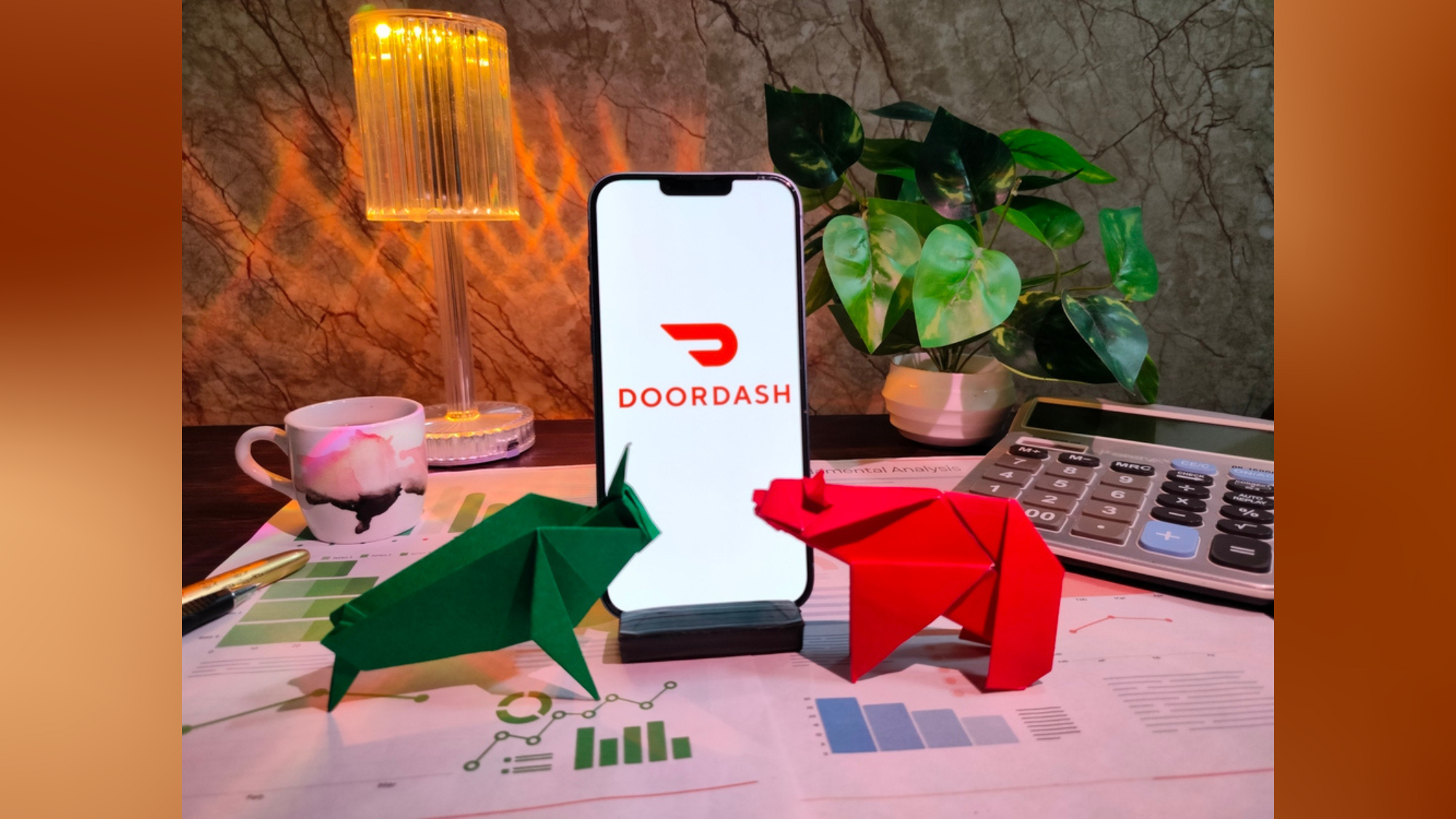Doordash logo positioned behind two origami creations—a bear and a bull.