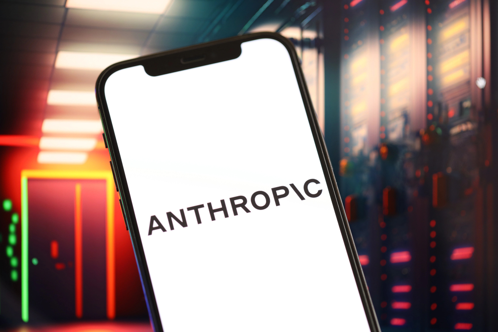 Anthropic logo on a smartphone with an AI-themed background.
