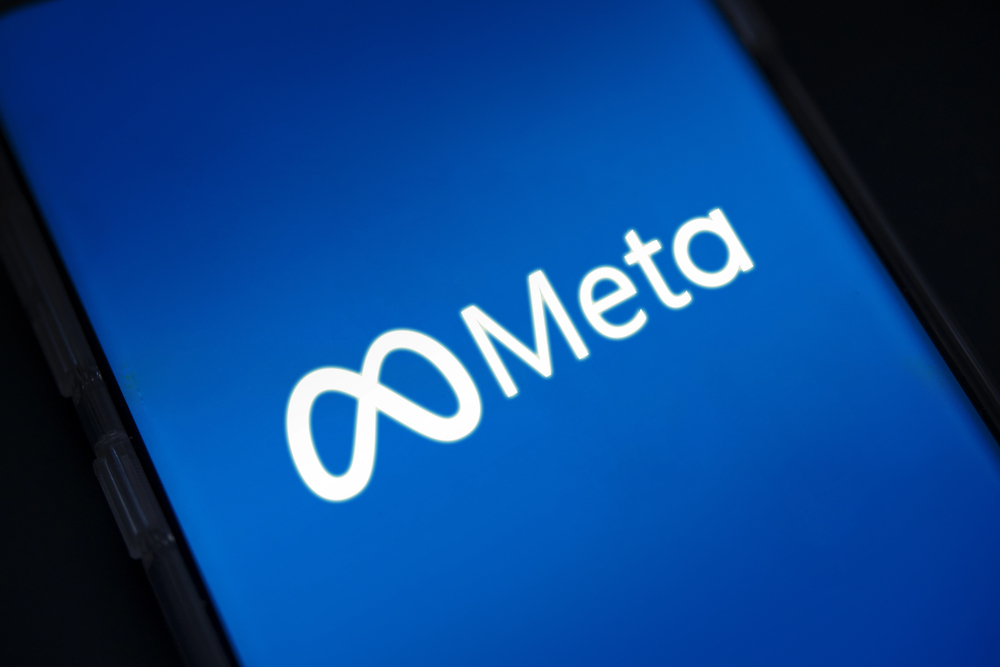 Close up of mobile phone screen displaying Meta logo.