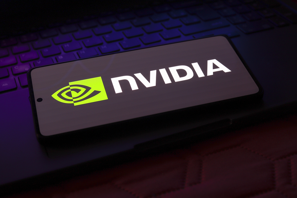 Nvidia logo displayed on a smartphone over a keyboard highlights chipmaker's AI demand outlook and stock momentum.