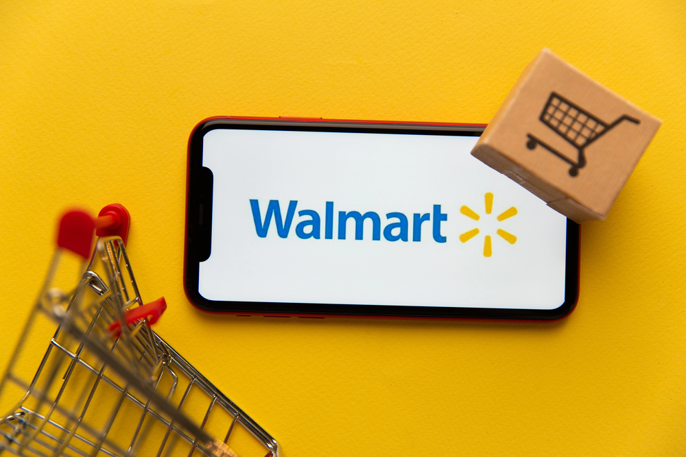Walmart logo positioned in front of a shopping cart.