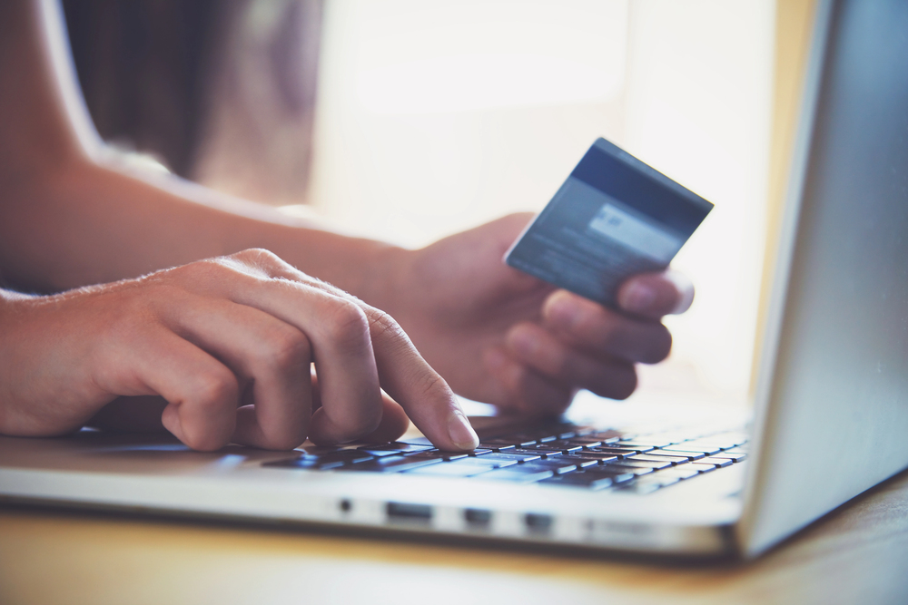 Consumer uses credit card to complete an online purchase.