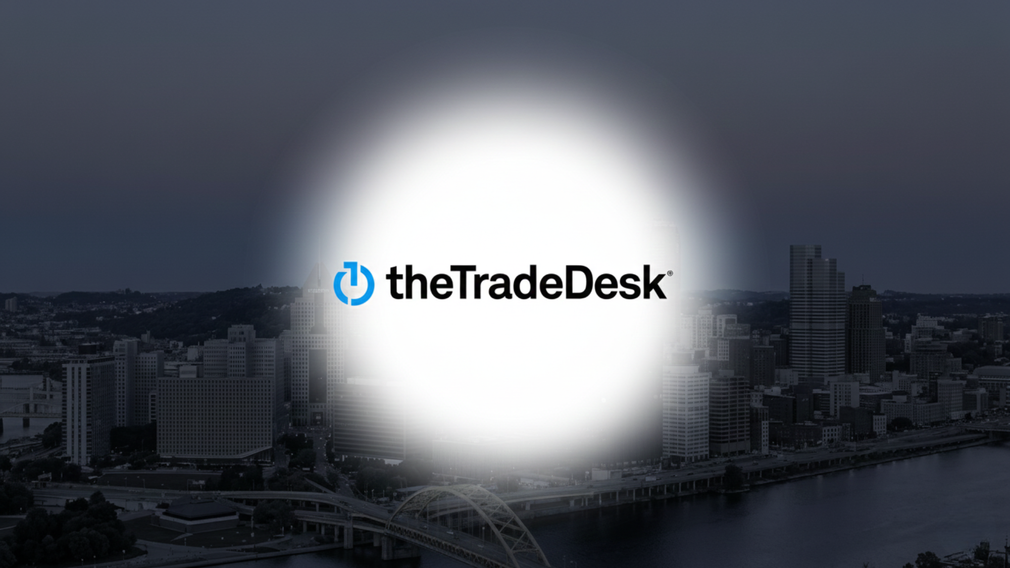 The Trade Desk logo featured in front of city skyline.